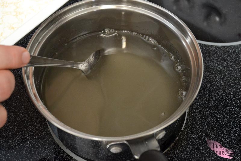 Stirring the sugar and water in a pan