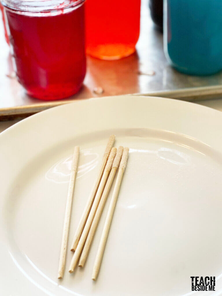 Sugar-coated skewers drying on a plate