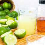 Ingredients for margaritas including limes, tequila, and orange liqueur
