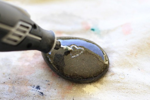 Engraving River Rocks with a Dremel and frequently dipping it in water to prevent overheating for rockscapes.net