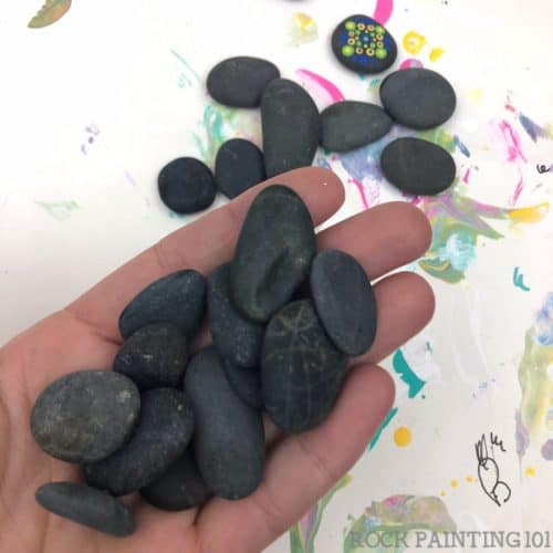 Collection of small, dark stones ideal for unique crafts and travel games.
