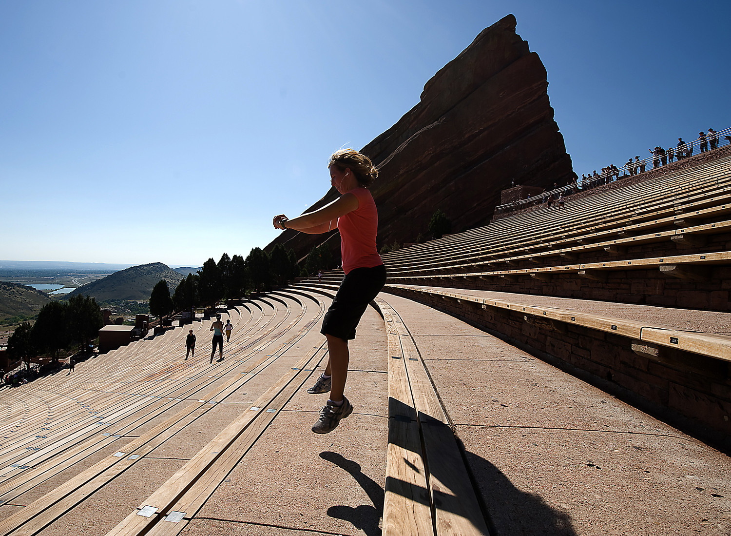 Hiker Jumping off Bench at Red Rocks