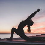 People practicing yoga and meditation at the outdoor park