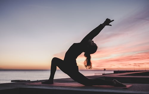 People practicing yoga and meditation at the outdoor park