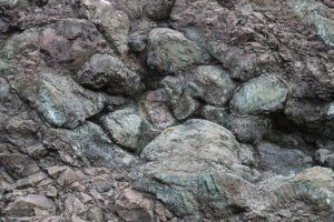 Pillow basalt often forms in layers covered by sediments