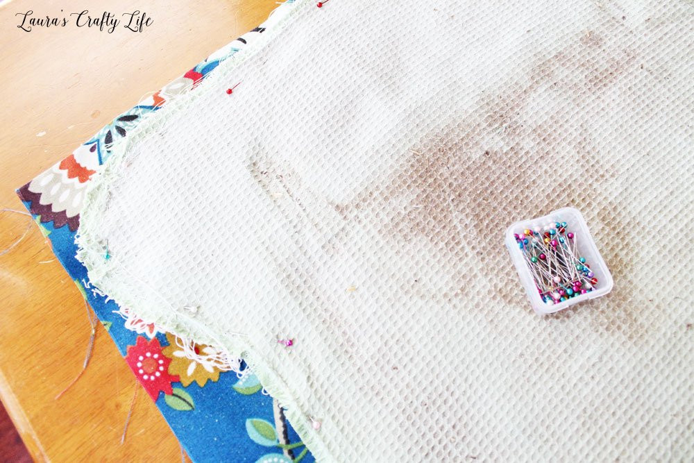 Pin the old cushion pieces to your new fabric