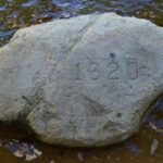 Granite rock texture with visible specks of quartz, feldspar, and mica, ideal for landscaping and construction