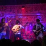 Polyphia performing live in 2019, showcasing their unique blend of math rock with intricate guitar work and dynamic stage presence