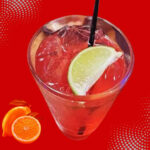 Ingredients to make Texas Roadhouse drink including lemons, blackberries, vodka and fruit syrups