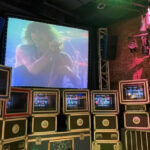 Aerosmith working at the mixing board to fine-tune a recording on Rock 'n' Roller Coaster Starring Aerosmith