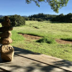 Rock Cairn with balanced stones and a blurred background, symbolizing balance and artistry in landscape design.