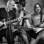 Rock band performing on stage with electric guitars