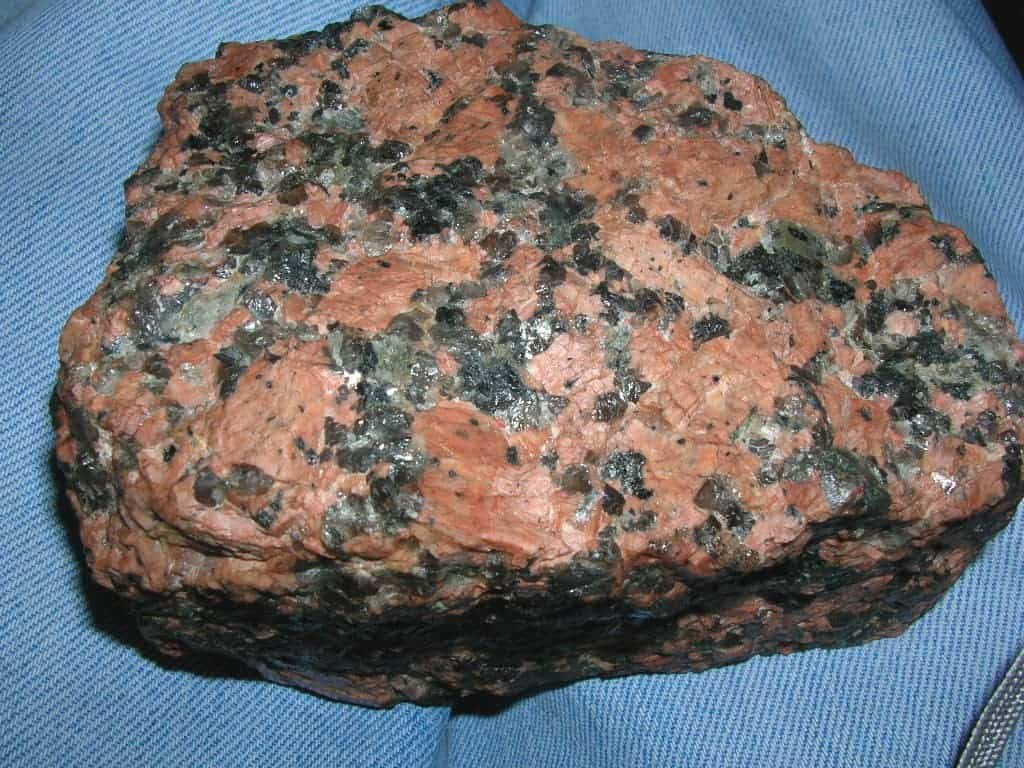 Granite with pink-reddish feldspar, black mafic minerals, and grey quartz