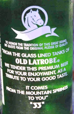 Rolling Rock beer bottle with classic green label