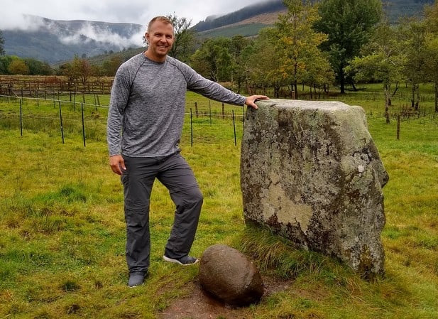 The author after successfully lifting the Puterach stone, weighing 230 pounds