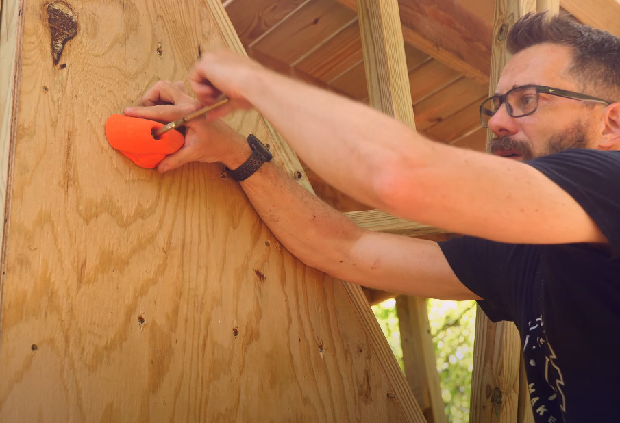 An outdoor climbing wall with integrated natural stone elements