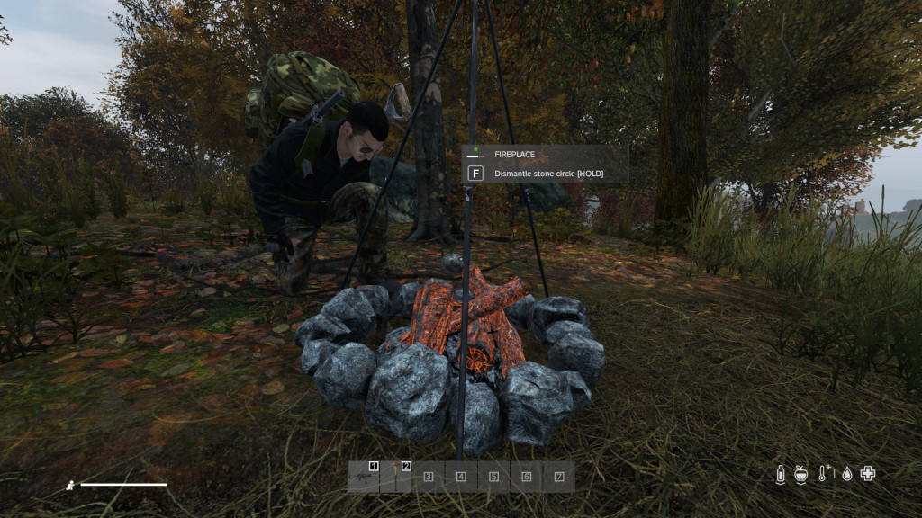 Dismantling a stone ring to recover the stones for relocation in DayZ