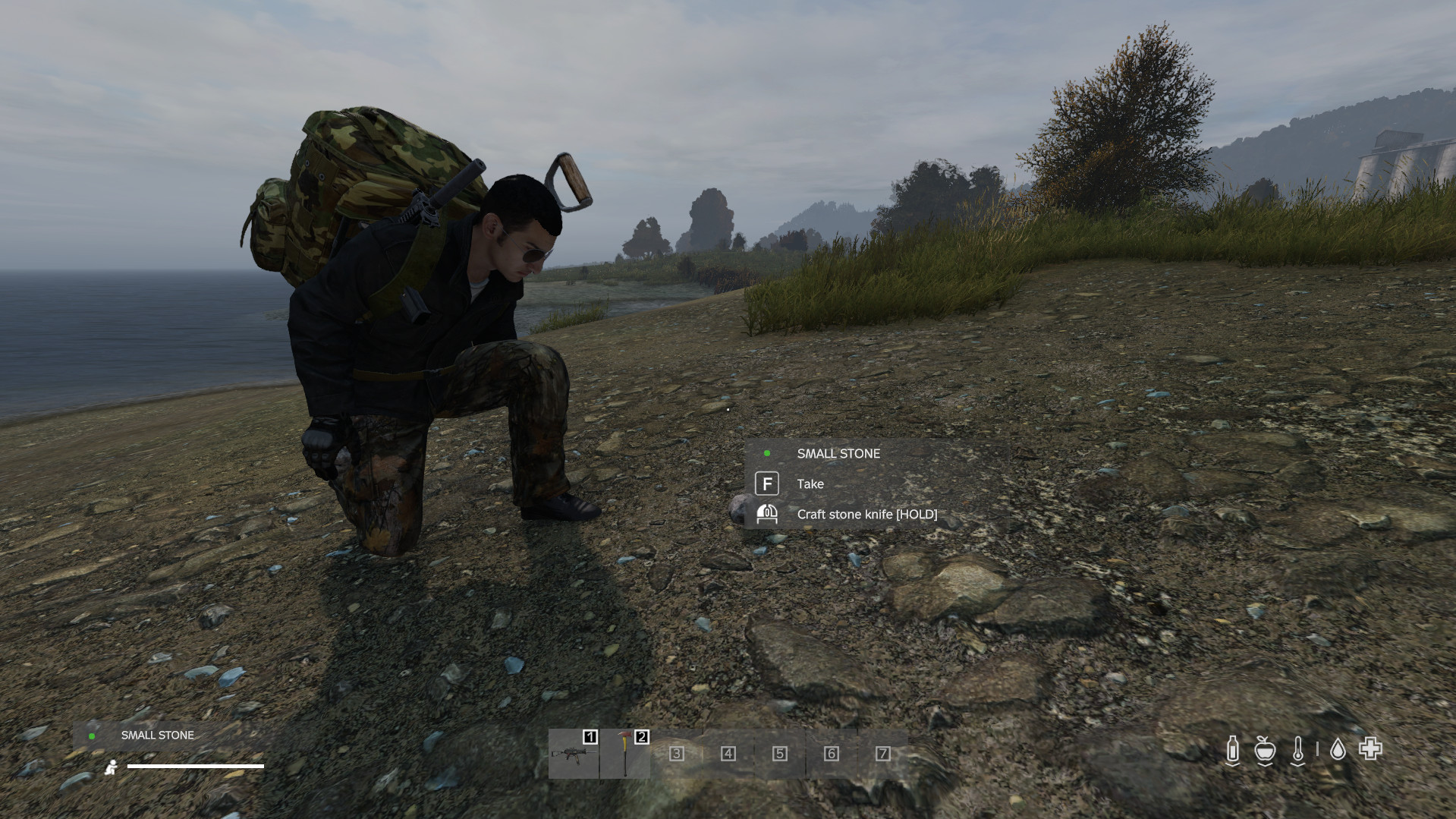 Combining two small stones to craft a stone knife, essential for early-game survival in DayZ