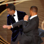 Chris Rock appears stunned after being slapped by Will Smith at the 2022 Oscars