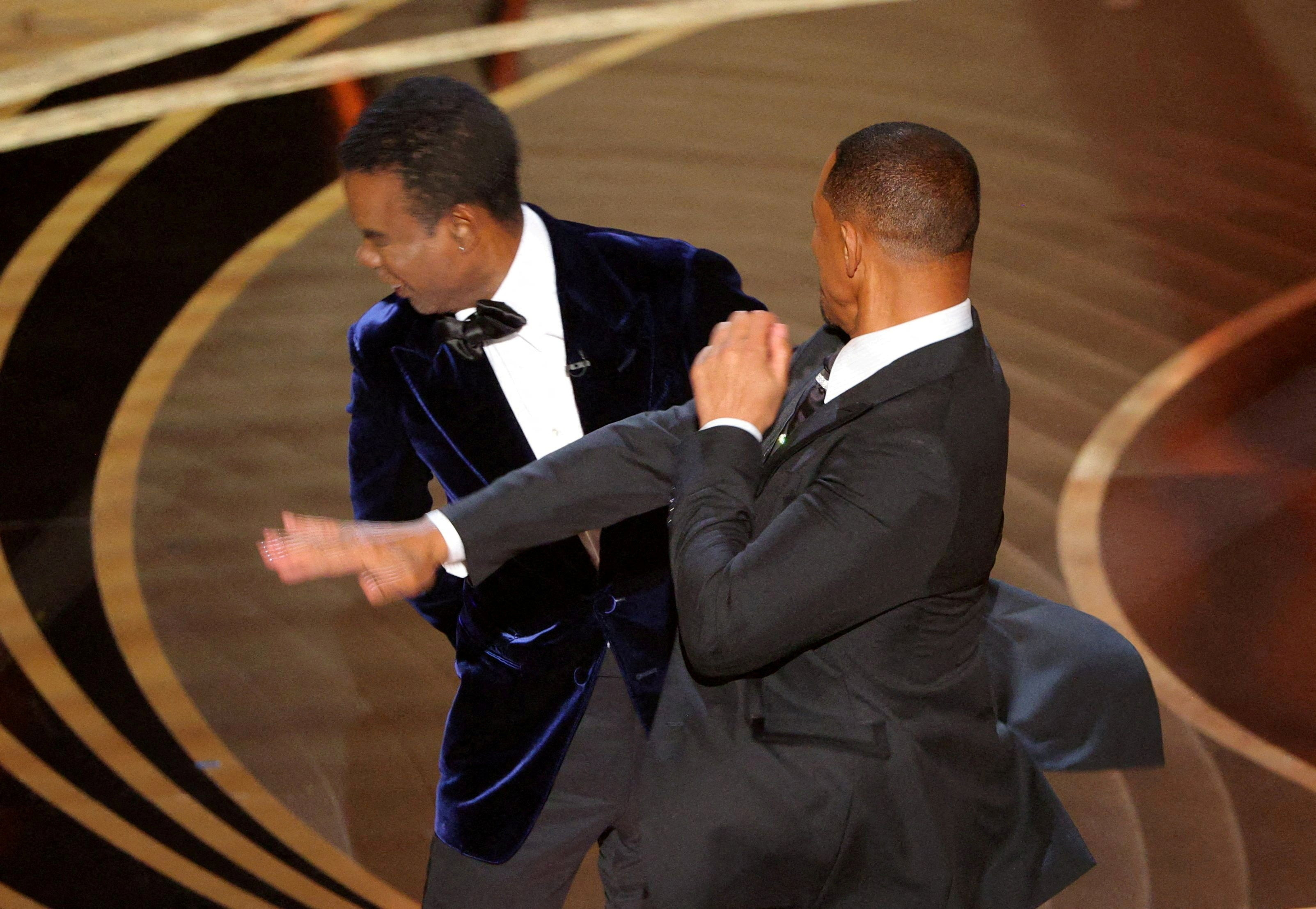Chris Rock appears stunned after being slapped by Will Smith at the 2022 Oscars