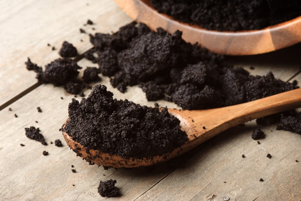 Coffee grounds scattered on snow, providing traction and a natural way to melt ice.