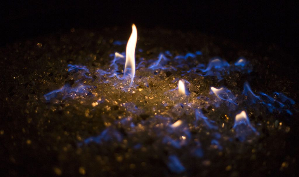 Fire pit filled with blue fire glass