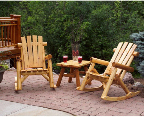 Wooden rocking chair on a porch with a view of a lake.