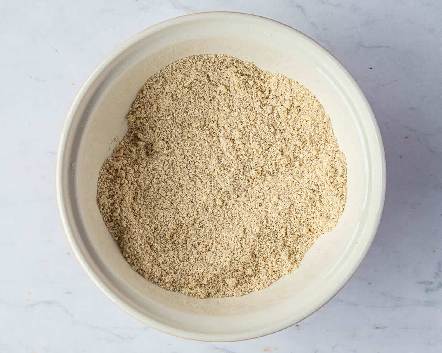 A photo showing the process of mixing ingredients for rock cakes, emphasizing the importance of cold butter and gentle mixing.