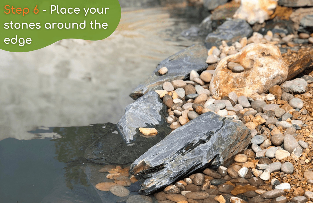 Arranging decorative stones around the edge of a pond