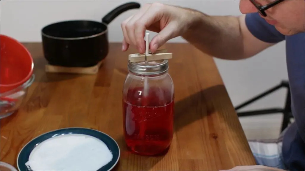 stick of sugar in red sugar solution