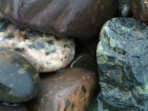 Orange quartz showing chips of white and black