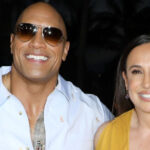 Dwayne Johnson and Dany Garcia smiling and posing for a photo, representing their past marriage