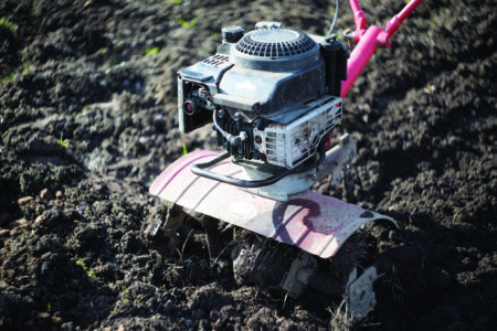 Tilling rocky soil with a cultivator for rock removal