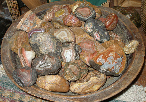 Fairburn agates in a wooden bowl, showcasing sensuality and vibrant energy.