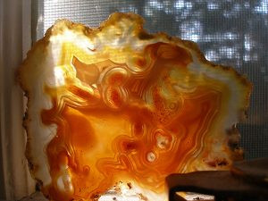 Laguna agate sun-catcher with the sun streaming through, creating a warm ambiance.
