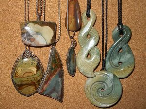 Morrisonite and New Zealand jade pendants showcased in a jewelry display.